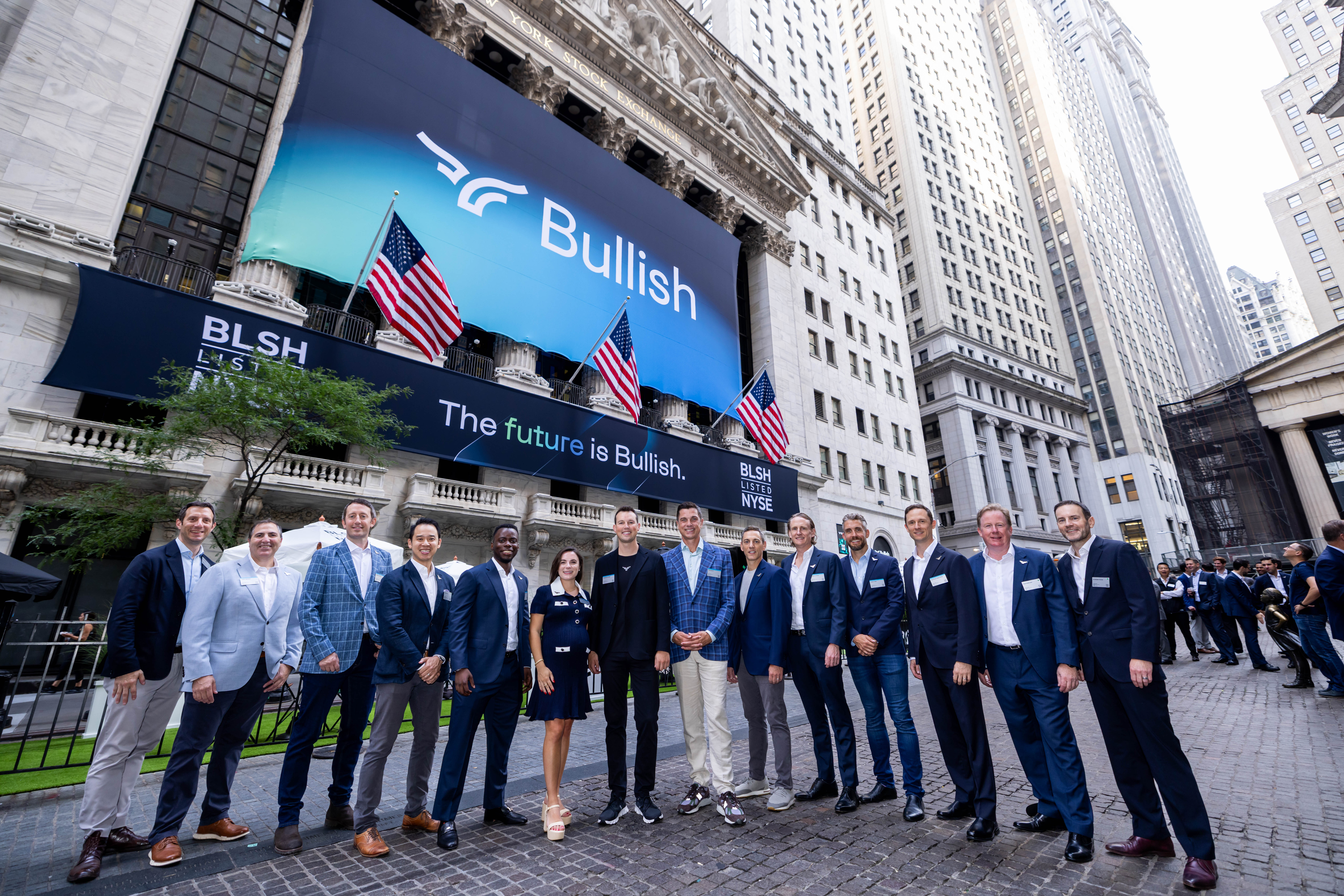 Bullish team outside the NYSE with 'The future is Bullish' banner